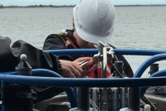 A student working with the CTD on the back of the R/V Savannah.