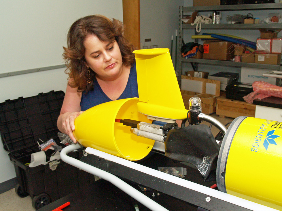 UGA Skidaway Institute of Oceanography researcher Catherine Edwards assembles the tail cone assembly of a glider. 