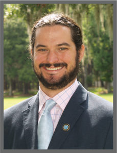 A photo of Dr. Buck in jacket and tie.