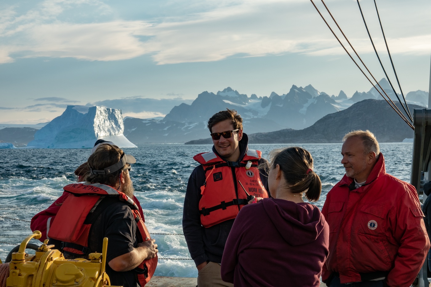 Foukal standing on a research vessel with glaciers in the background.