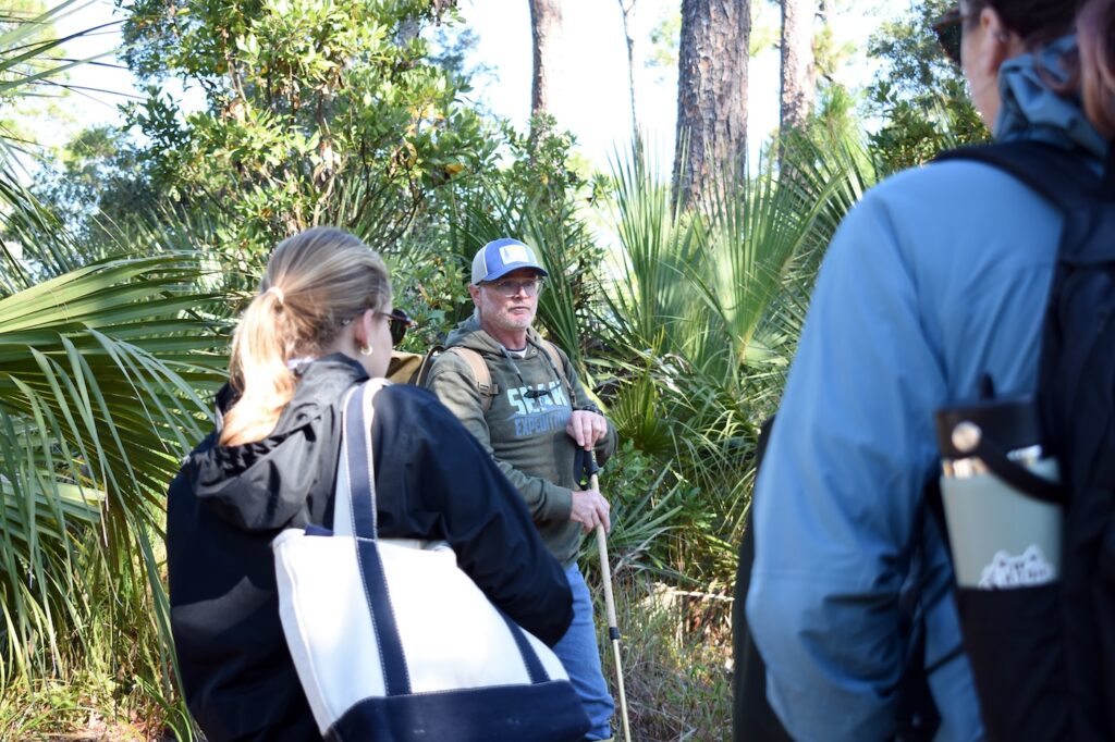 Mike Robinson (center) talks to students about native plant life on Wassaw Island. 