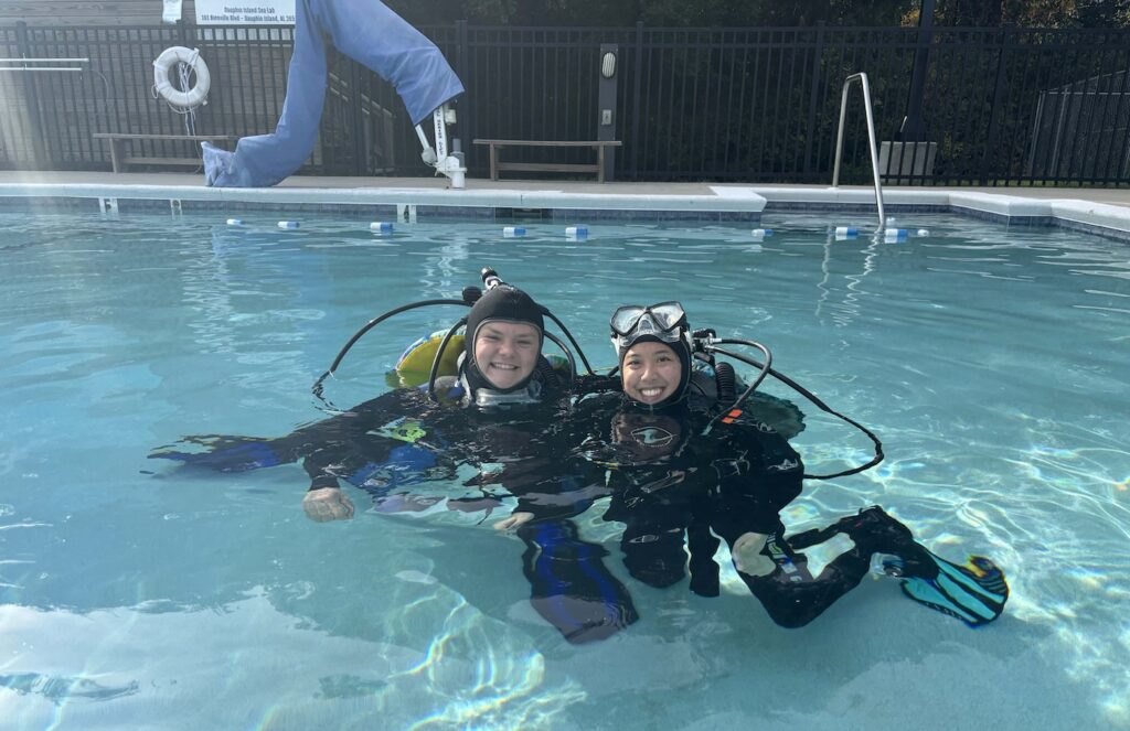 McCaffrey and another intern scuba diving in a pool. 