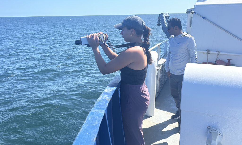 Ohall taking reflectance measurements aboard the RV Savannah.